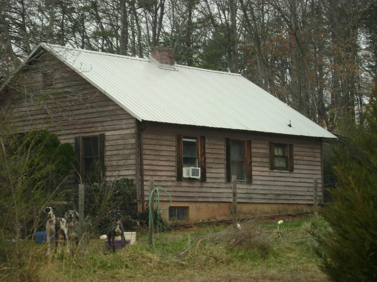 White metal roof on an old wood sided farmhouse, from a Metal Roof Installation job in Vonore